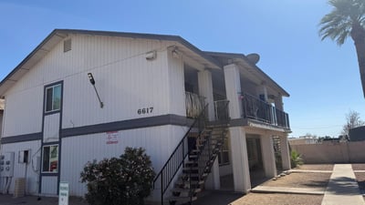 Inviting exterior perspective showcasing the property's well-kept grounds, designated parking, and mature landscaping. Residents enjoy a convenient Glendale location near dining, retail, and recreational opportunities.