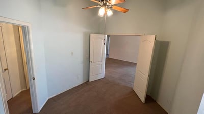 Spacious bonus room featuring high ceilings and flexible use potential. Perfect for remote work, guests, a fitness area, or additional living space tailored to your needs.