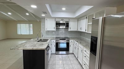 Bright kitchen offering extensive counter space, stainless appliances, and ample cabinet storage. The open layout makes meal preparation and entertaining easy.