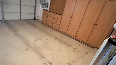 Two-car garage with extensive custom storage cabinets, built-in work area, and generous space for vehicles, tools, and recreational equipment, making organization simple and efficient.