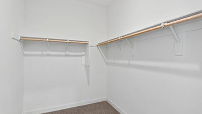 This generously sized walk-in closet provides extensive hanging space and storage, making it easy to organize your wardrobe while complementing the spacious primary suite.