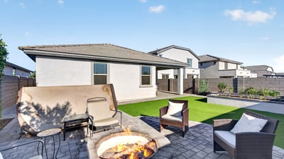 Entertain family and friends around the custom fire pit while enjoying professionally landscaped outdoor living spaces, artificial grass, and inviting patio seating areas.