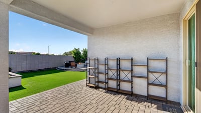 Enjoy shaded outdoor living beneath the covered patio while overlooking the beautifully landscaped backyard with low-maintenance artificial turf and entertaining spaces.