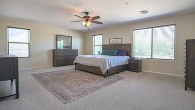 Large primary suite with abundant natural light, generous floor space, and room for additional seating or a private retreat. Designed for comfort and relaxation.