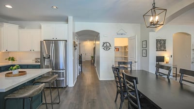 Expansive kitchen and dining area showcasing quartz countertops, oversized island seating, and a seamless flow that's ideal for hosting family and friends.
