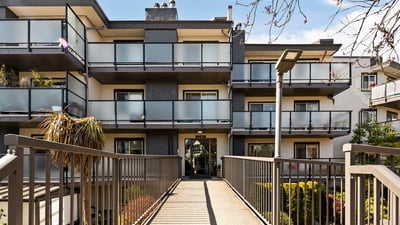 Modern multi-unit building featuring spacious balconies and easy access to landscaped outdoor areas.