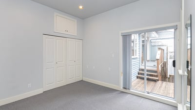 Bright, versatile room with large closet and direct access to a private outdoor space.