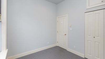 Bright and spacious room with neutral tones, offering ample storage and potential for customization.