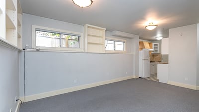 Bright, versatile space with ample natural light, perfect for a home office or cozy gathering area.