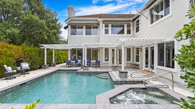 Discover a spacious outdoor oasis featuring a refreshing pool, spa, and ample lounging areas for relaxation.