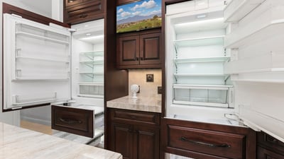 This gourmet kitchen features dual Sub Zero refrigerators, 4 pull out freezer drawers with ample storage, fun appliance garage and modern finishes for culinary enthusiasts.