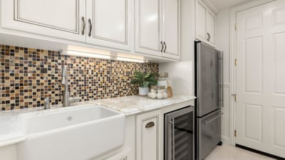 Modern Laundry room featuring a unique mosaic backsplash, spacious sink, and upgraded stainless steel appliances (Fridge and Wine Fridge included)