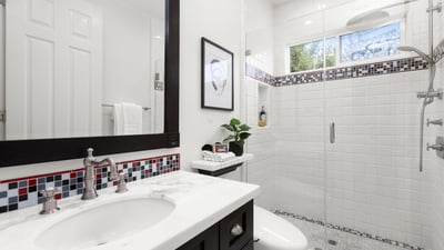 Bathroom 2-Modern bathroom featuring a spacious walk-in shower, sleek fixtures, and vibrant tile accents.