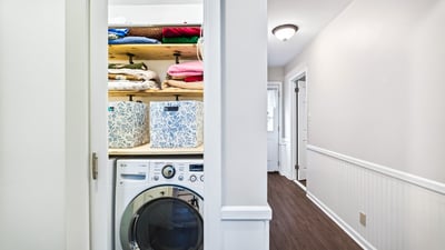 Efficient laundry closet with storage.