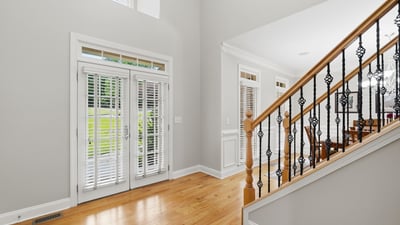 Welcoming foyer features modern design and abundant natural light, leading to an open dining area.