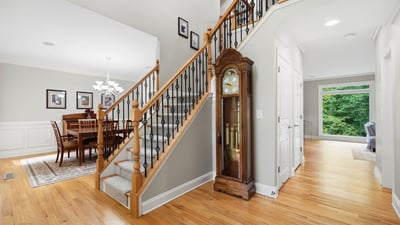 Discover a spacious entryway leading to a bright dining area, complemented by stunning wood details.