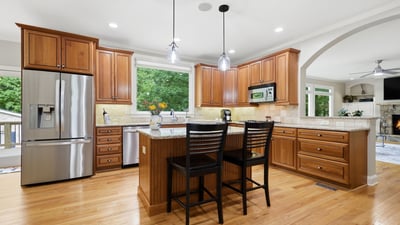 Spacious kitchen featuring custom cabinetry, modern fixtures, and an inviting island perfect for hosting gatherings.