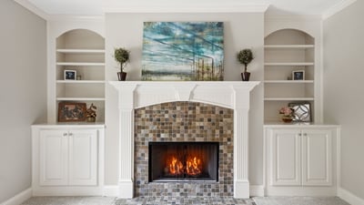 Cozy living room featuring a striking fireplace and built-in shelving for personalized decor.