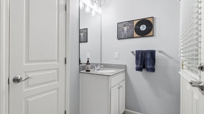 Bright and functional bathroom featuring modern fixtures, a spacious countertop, and contemporary decor.