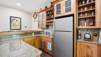 This well-appointed kitchen features ample storage, modern appliances, and a lovely granite countertop perfect for entertaining.