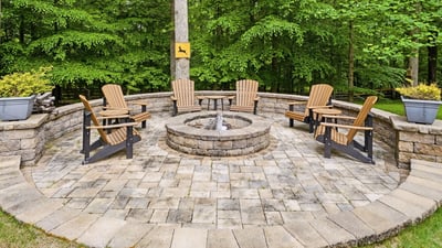 Inviting fire pit area surrounded by nature, perfect for gatherings and cozy evenings outdoors.