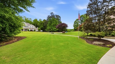 Expansive, well-maintained grounds offer ample space for outdoor activities and potential landscaping projects.