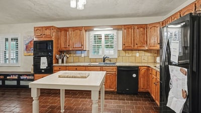 Kitchen with refinished real wood cabinets and new granite countertops.