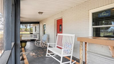 View of the Front Porch, which is fully screened to enjoy an evening drink all while taking in that immaculate Florida sunset!