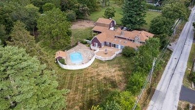 Spacious property featuring a pool, surrounded by lush greenery, perfect for outdoor activities and relaxation.