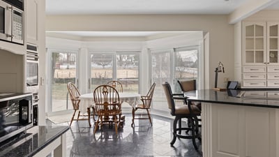 Spacious kitchen features large bay windows, ideal for natural light and relaxed dining experiences.