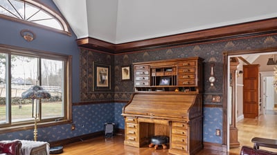 Spacious living area featuring unique architectural details and rich wood finishes, perfect for relaxation and gatherings.