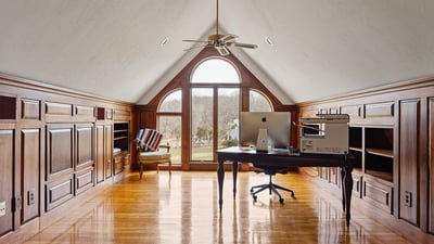 Bright and airy loft office with expansive windows, custom cabinetry, and stunning panoramic views.