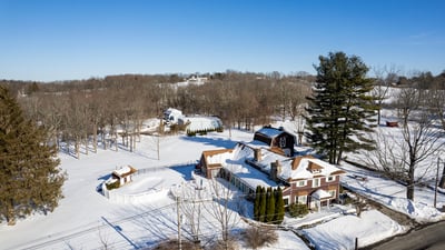 Spacious country property with expansive snow-covered grounds and classic architecture, perfect for year-round living.