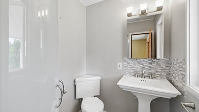 Modern bathroom featuring sleek fixtures, a spacious shower, and contemporary tile accents for a fresh look.