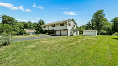 This spacious home features a large yard, ample parking, and scenic views in a quiet neighborhood.
