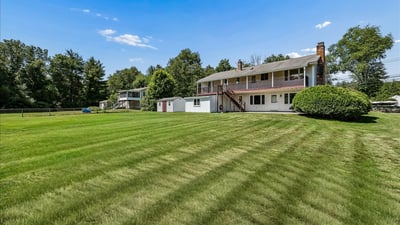Spacious property featuring a large backyard and a multi-level home, perfect for outdoor gatherings and relaxation.