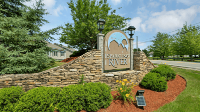 Discover the inviting entrance of Sparkling River, featuring beautiful landscaping and a welcoming community vibe.