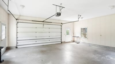 Spacious garage with ample storage and natural light, perfect for parking or a workshop area.