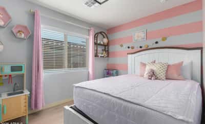 This charming secondary bedroom features updated flooring, large windows, and flexible space perfect for children, guests, or a home office, adding versatility to this beautiful Buckeye home.