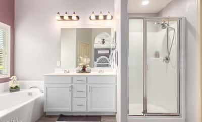 Enjoy a bright primary bathroom complete with dual vanities, a soaking tub, separate walk-in shower, and modern finishes that provide comfort and functionality for everyday living.