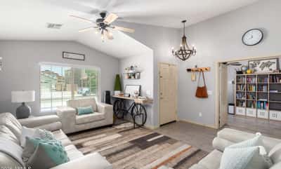 Filled with natural light and enhanced by vaulted ceilings, this spacious great room offers flexible living space that flows effortlessly into the dining area, making it perfect for entertaining.