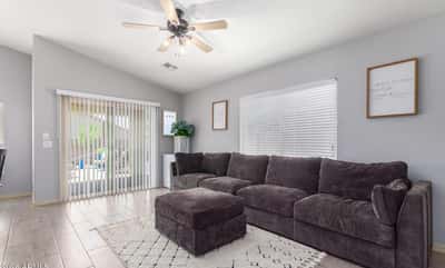 Relax in this inviting family room featuring large windows, ceiling fan, updated flooring, and direct access to the backyard patio. The open layout makes entertaining effortless while maximizing natural light.
