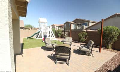 Host outdoor gatherings on the expansive paver patio surrounded by easy-care landscaping and artificial turf. The spacious backyard offers room to relax, entertain, and enjoy Arizona living in Buckeye.