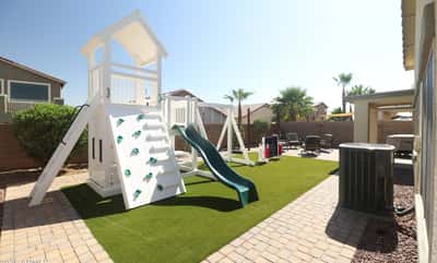 Families will appreciate the spacious backyard featuring a premium playset, artificial turf, paver walkways, and generous open space for recreation, entertaining, and everyday enjoyment.