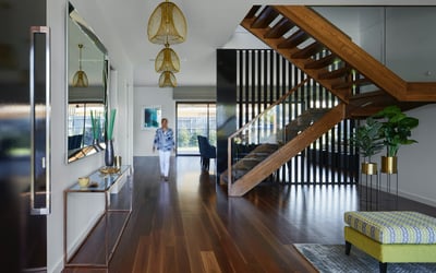 Stunning entryway featuring modern design, elegant lighting, and warm hardwood flooring, perfect for stylish living.