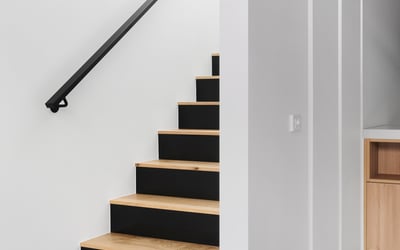 Discover modern elegance in this stylish, bright staircase leading to expansive upper living spaces.