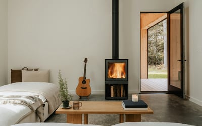 Cozy retreat featuring a warm fireplace, inviting seating, and seamless indoor-outdoor connection.