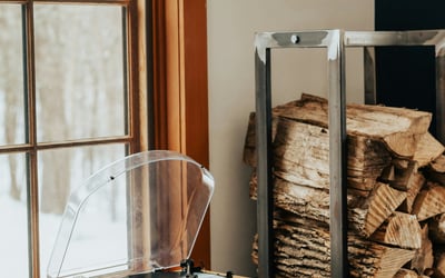 Cozy space featuring a vintage turntable beside a neatly stacked pile of firewood, perfect for relaxation.