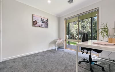 Bright and spacious room with large windows, offering peaceful views and ample natural light for productivity.