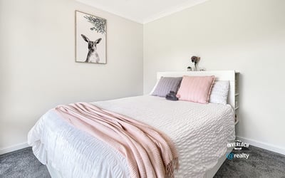 Bright and inviting bedroom featuring modern decor, soft textiles, and a peaceful atmosphere for relaxation.